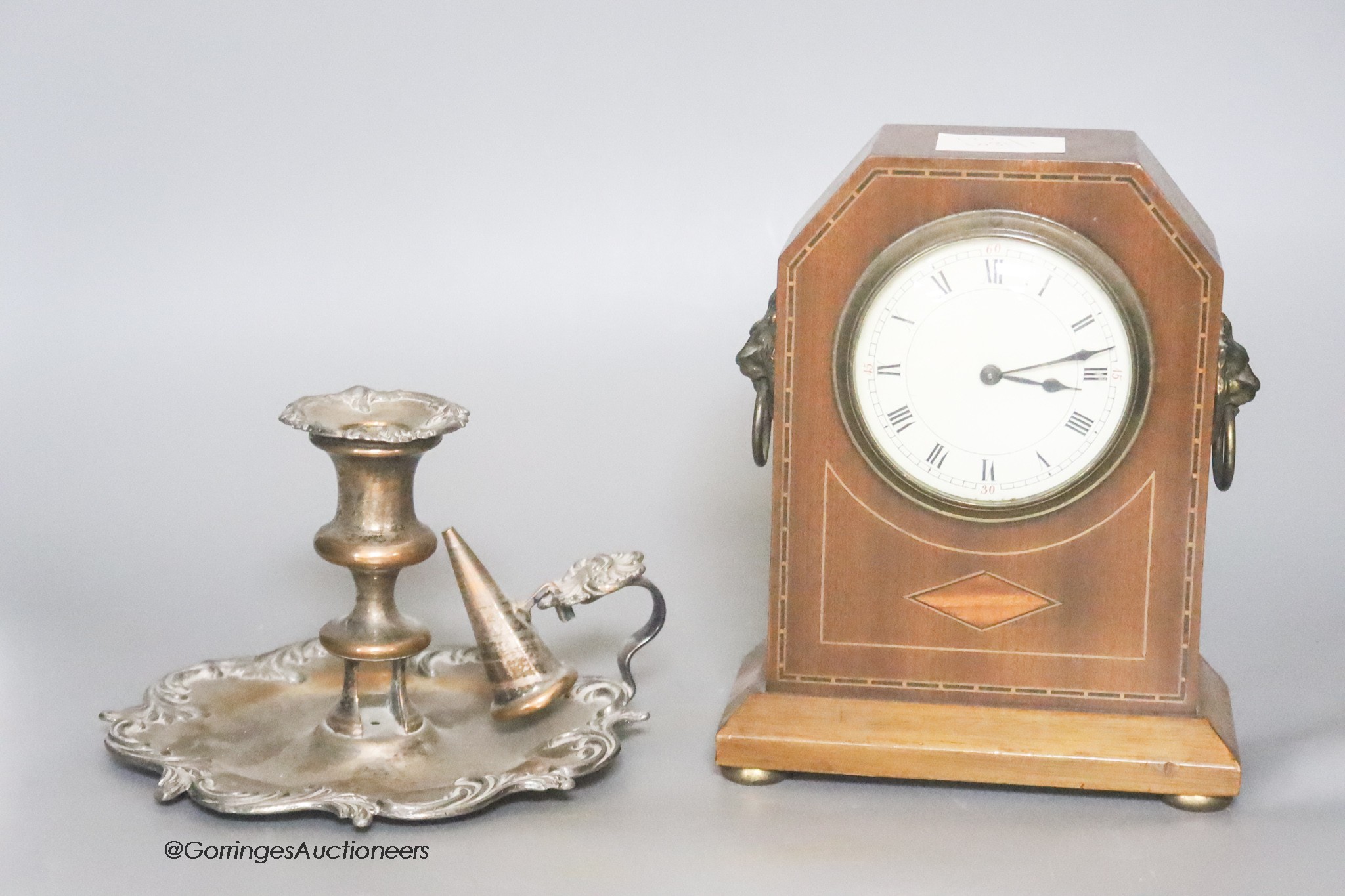 An Edwardian mahogany mantel timepiece, together with a silver plated chamberstick